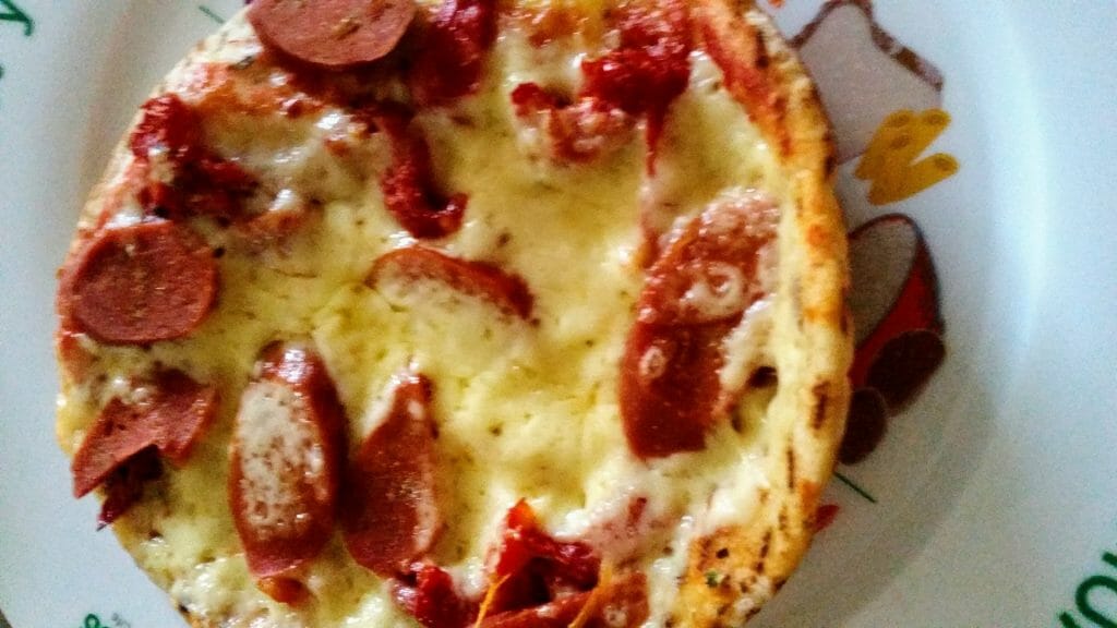 Pizza with cheese sundried tomatoes sanitarium hot dogs