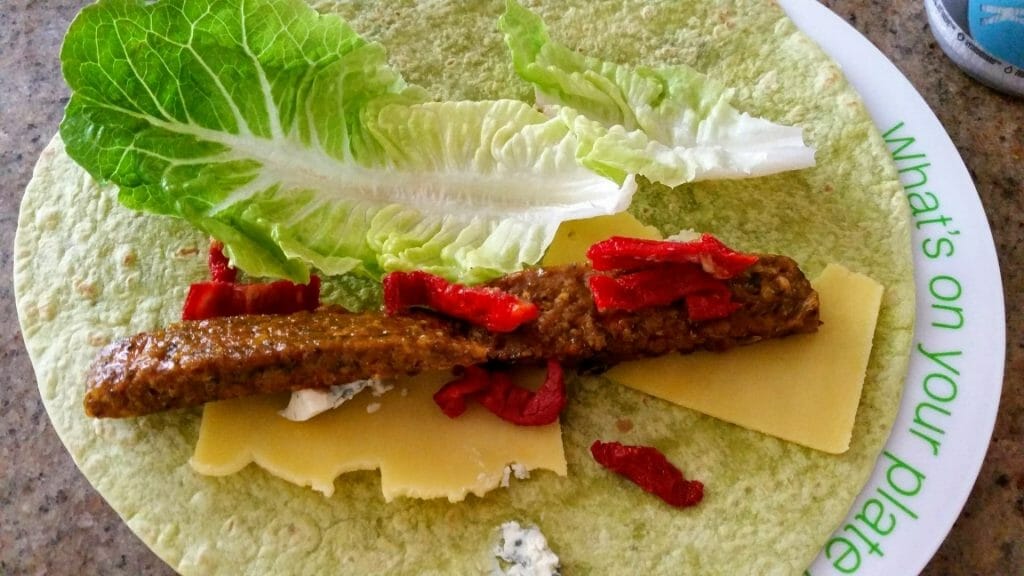 Wrap with vegetarian spiced lentil & kale koftas, slice of cheese, blue cheese, lettuce, sundried tomatoes and mayonnaise